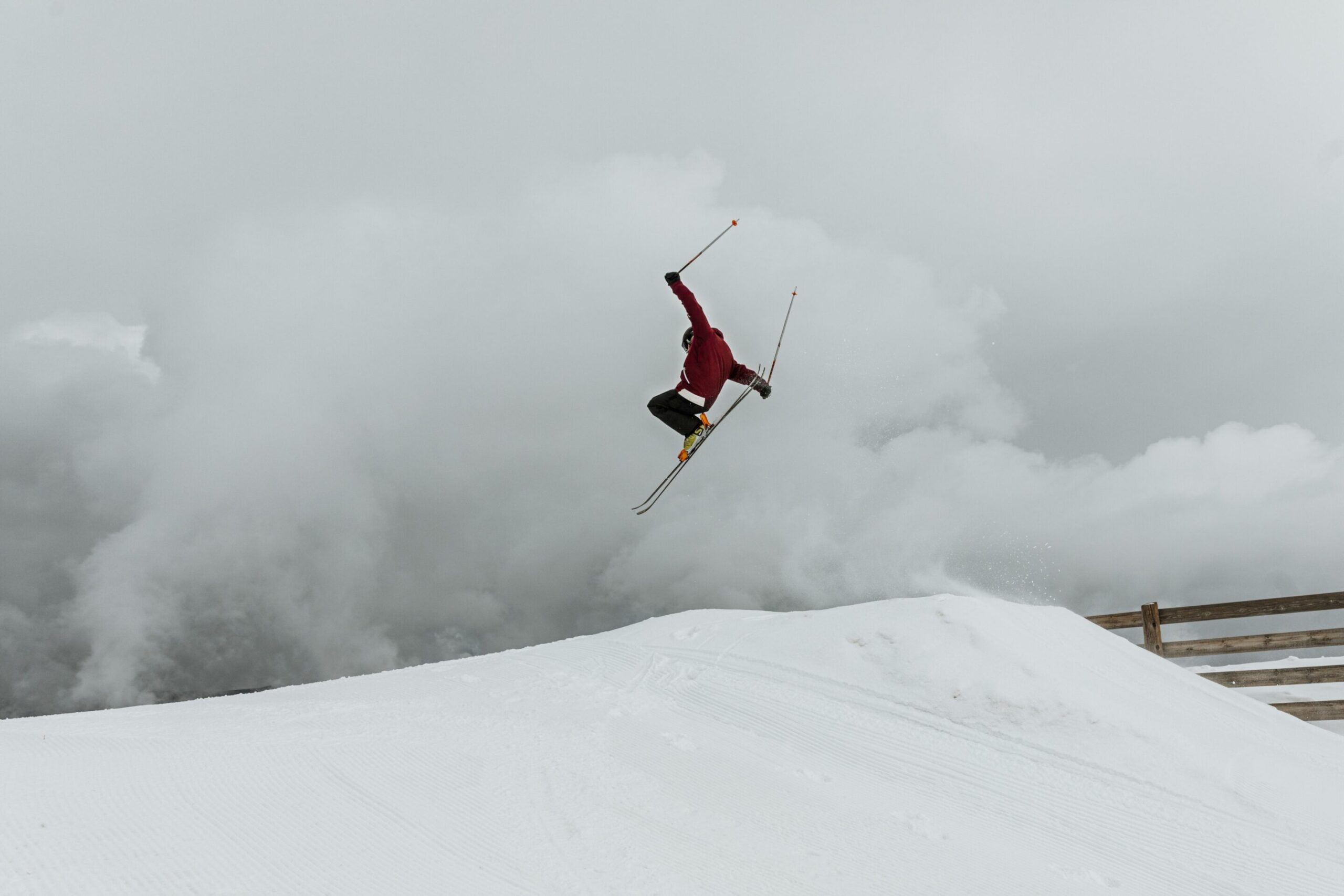long-shot-skier-jumping-over-hill-scaled